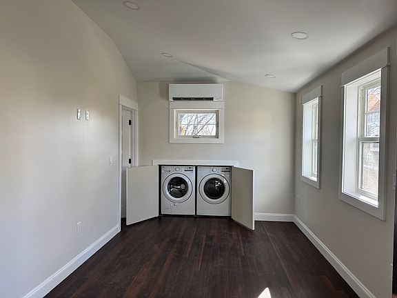Living room with in-suite washer and dryer