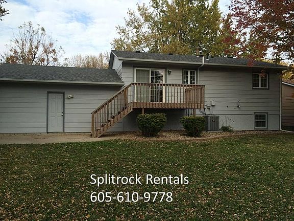 Large deck and patio overlooking fenced back yard