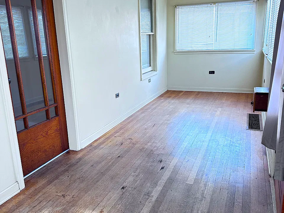Enclosed Front Porch with lots of Windows and Light.