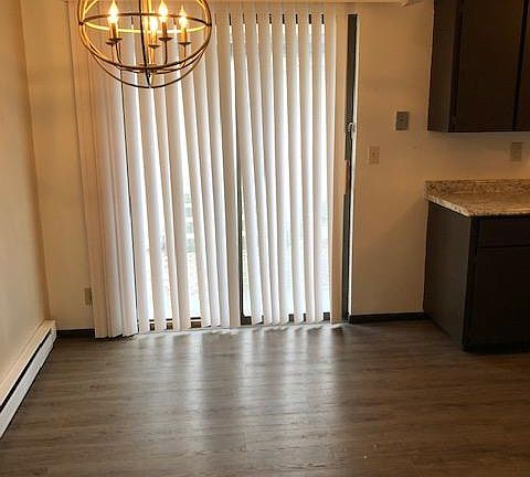 Dining room with plank flooring and custom lighting