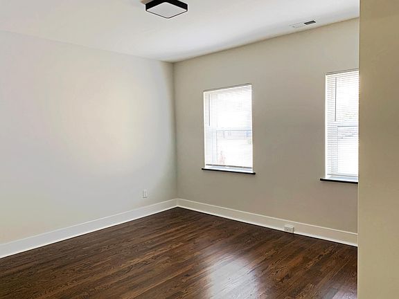 Single bedroom with newly refinished hardwood floors and ample closet space.