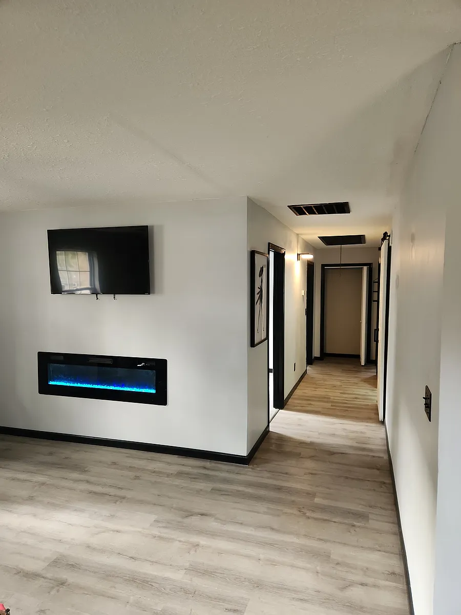 LIVINGROOM COMES WITH A 50 INCH TV AND A BEAUTIFUL WALL MOUNTED 60 INCH FIREPLACE. - 1005 Johnston St