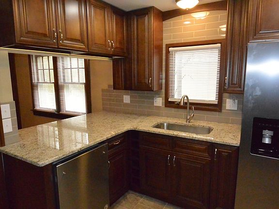 42 inch cabinets with 6 slot wine cube next to sink cabinet. Large fridge with water dispenser and built in ice maker.