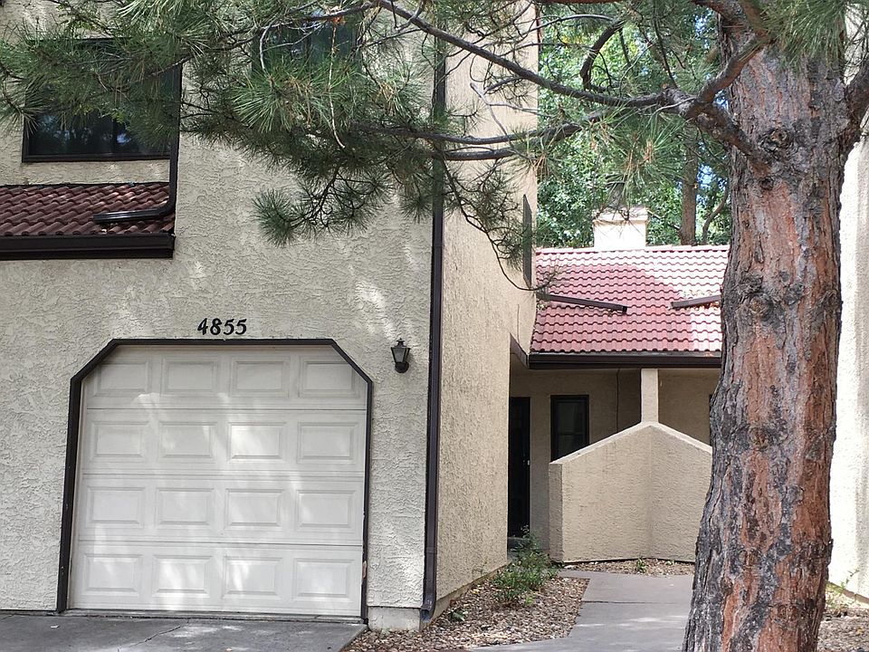 Front of condo with garage and driveway