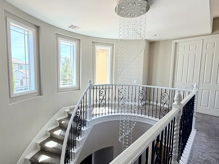 13 foot crystal chandelier with winding staircase. French doors open to master bedroom