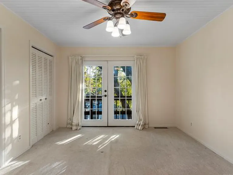 Top floor bedroom with French doors to private balcony.