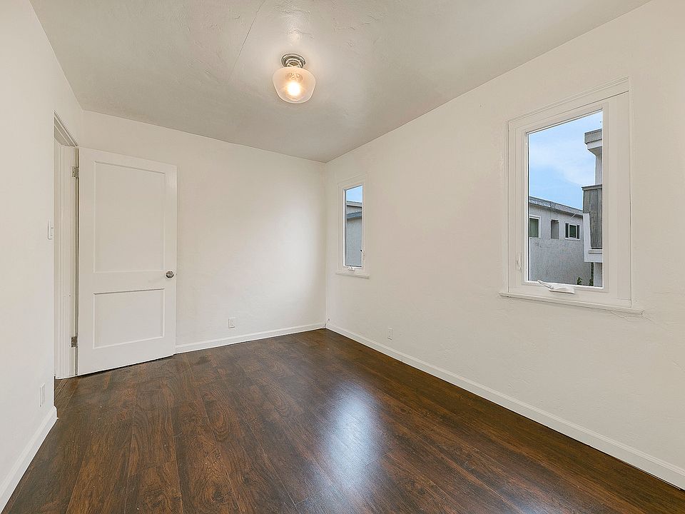 Large bedroom with wood floors, closet, and windows for ocean breezes in beautiful Santa Monica