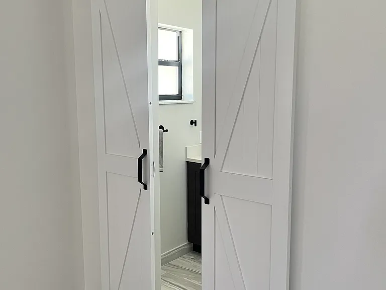 Barn doors to primary bathroom