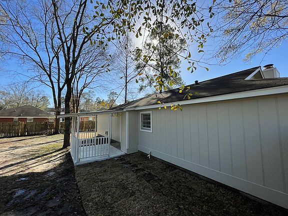 Side of house in back. Fence is now installed along the grass line.