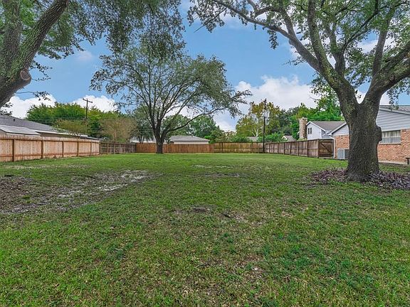 View from the street of this generously sized lot on tree lined Meadow Lake Ln.
