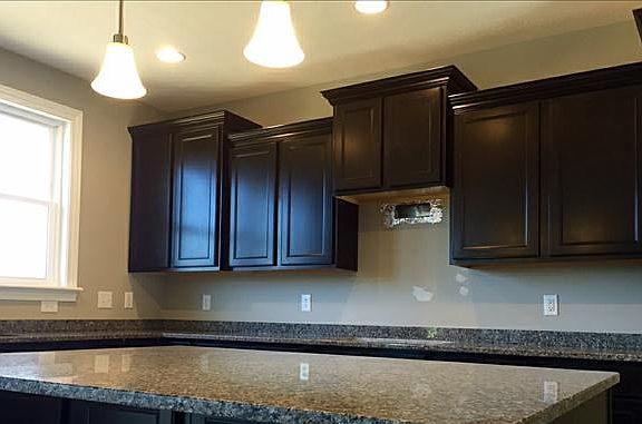 Staggered cabinets with granite counter tops.