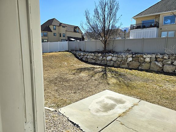 Spacious landscaped, fully fenced backyard with open patio