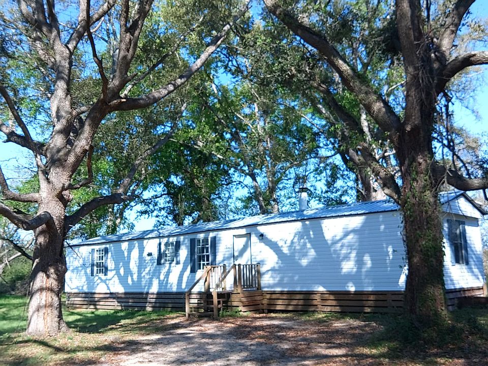 Beautiful, mature oaks on all sides provide shade year-round