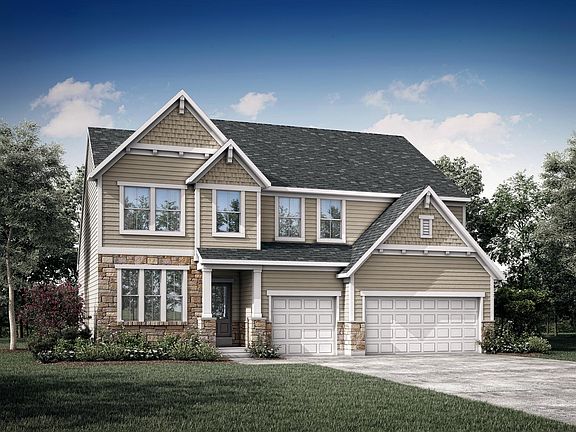 custom two-story home with stone, siding, shakes and three-car garage
