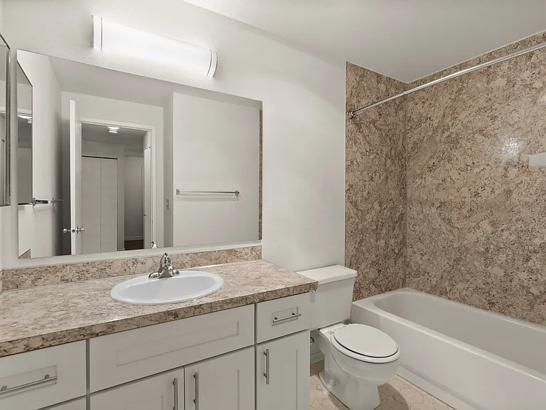 Modern bathroom with elegant marble walls, sleek vanity, and bright lighting, offering a luxurious and functional space. Modern bathroom with elegant marble walls, sleek vanity, and bright lighting, offering a luxurious and functional space.
