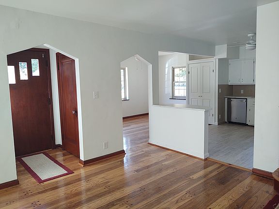 View of front door entrance, coat closet, dining room and kitchen from the living room