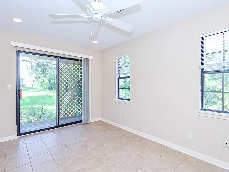 Bedroom with view toward sliding glass doors leading to deck.