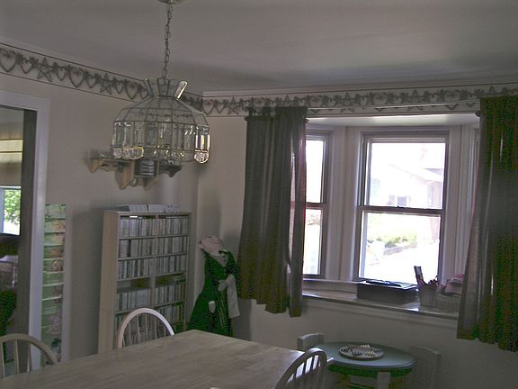 formal dining room with archway top living room and bay window