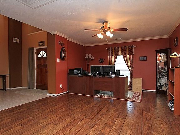 Perhaps the most impressive room is the "great room" which measures over 28 ft long and comprises the study/office area and dining area. Gorgeous laminate flooring and crown molding adorn this mammoth space. This view shows < 1/2 of the space.