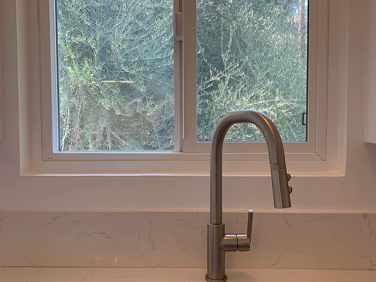 Kitchen sink with treetop views