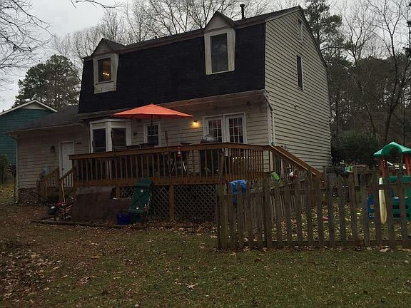 back of house with fenced kid play area