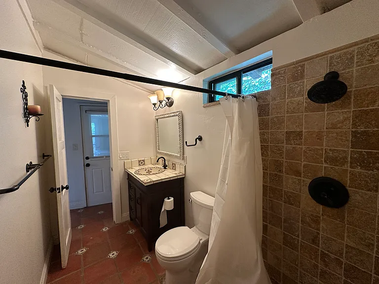 Bathroom with walk-in shower and Saltillo floor tile