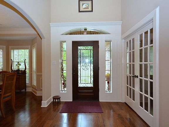 Vaulted two story entry makes you feel right at home after entering through the decorative leaded gl