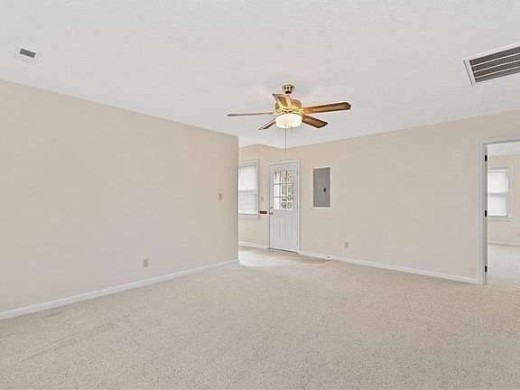 Living room space with view of bedroom (1) and door to private balcony