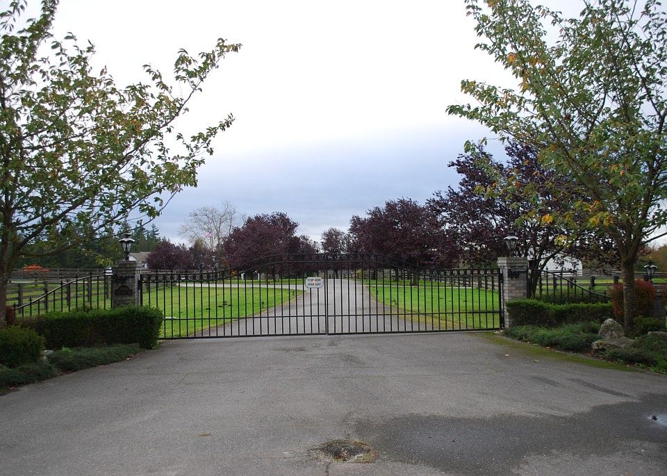 Gated entry leading into this magnificent property, lined with brilliant colored trees.