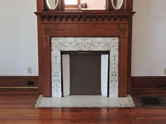 one of 5 mantles and fireplaces