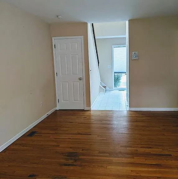 Living Room, view to the foyer and door to the Basement