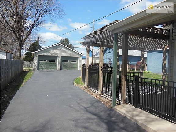 Long drive with ample parking leads to two-car garage and alley access.