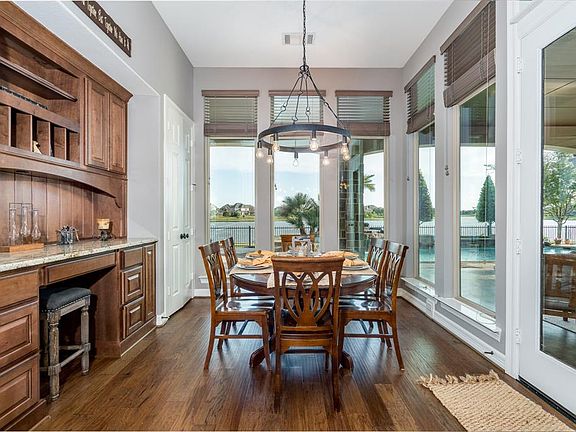 Breakfast area is surrounded by windows and an amazing view of the backyard. Windows bring in a lot of natural light to help get a good, positive start to your day. Desk area, to the left, is a perfect work space for you or study place for the childr