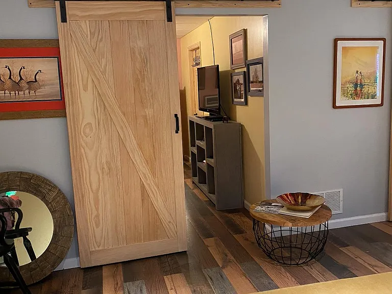 Barn doors provide the bedroom and laundry area with privacy.