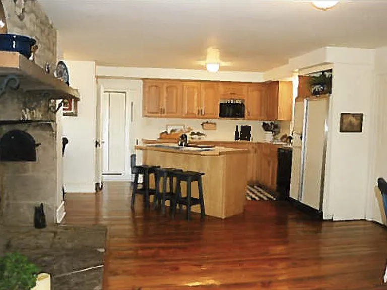 Large kitchen with eat-in dining space, center island, laundry room off to side