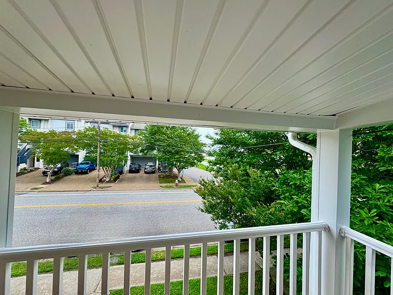 Balcony off of master bedroom, beach access shown right across the street.