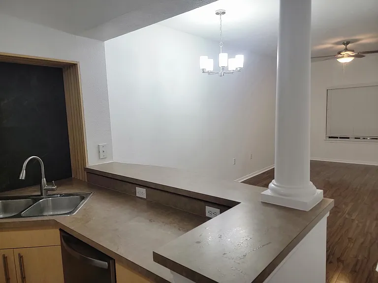 Kitchen entry, leading into family room. Bar and seating area.