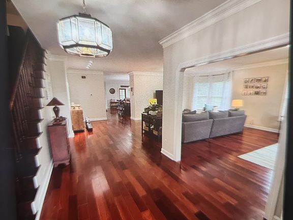 Brazilian cherry (jatoba) hardwood covers the great room floor that is open to the foyer and stairway. Current tenants use the front portion of the great room as a homeschool office open to the sitting area that includes a bay window.