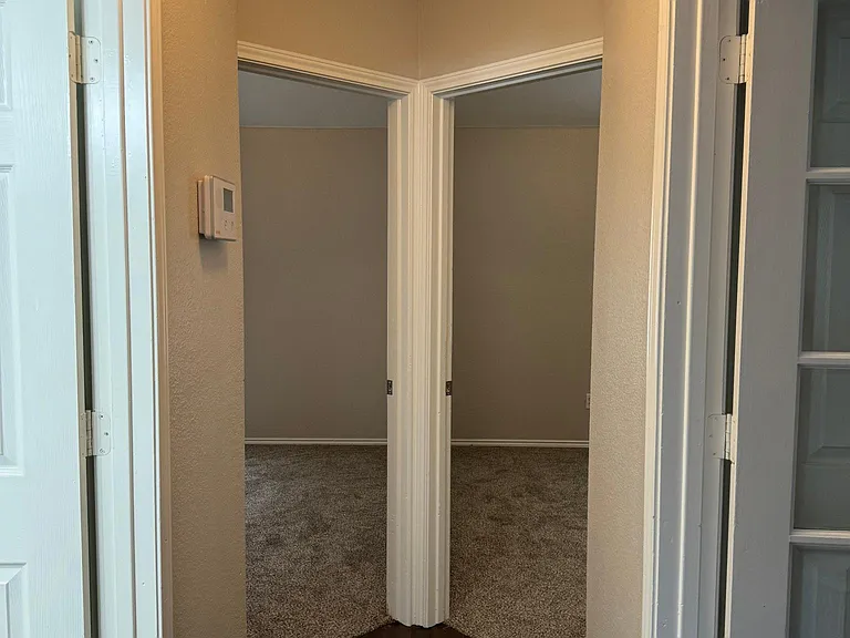 Hallway
Left room is to bathroom
RIght with glass door is to the washer/dryer room