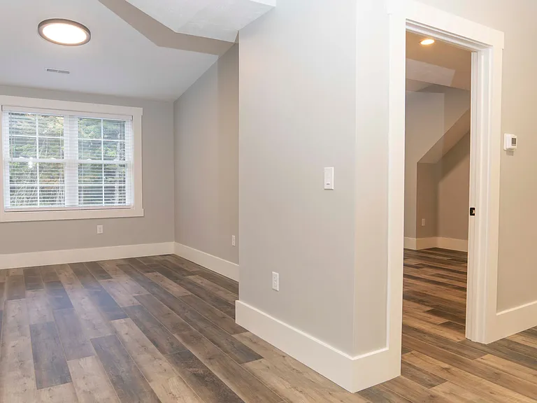 Living room (left), bedroom door (right).