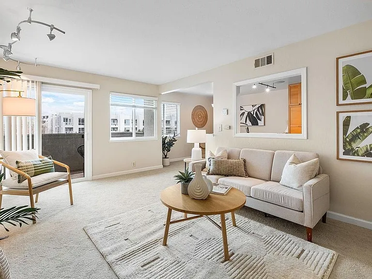 Open living room with sliding door to balcony and lots of natural light. Views of Mt. Diablo out all windows