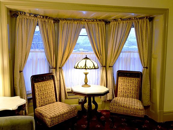 Bay windows in living room with a nice view of gardens