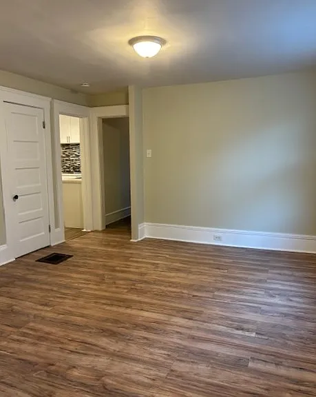 Living/dining room with coat closet, entry to kitchen and hallway to bedrooms.