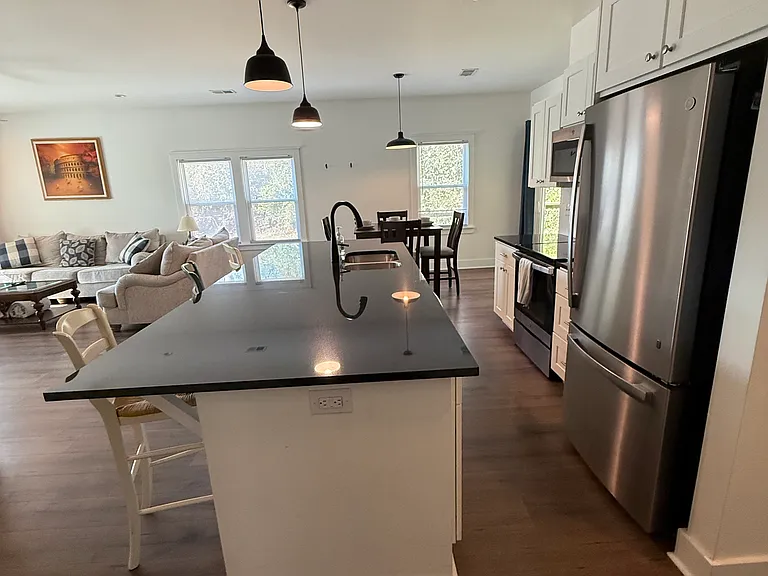 Open kitchen, dining room, island has 3 stools