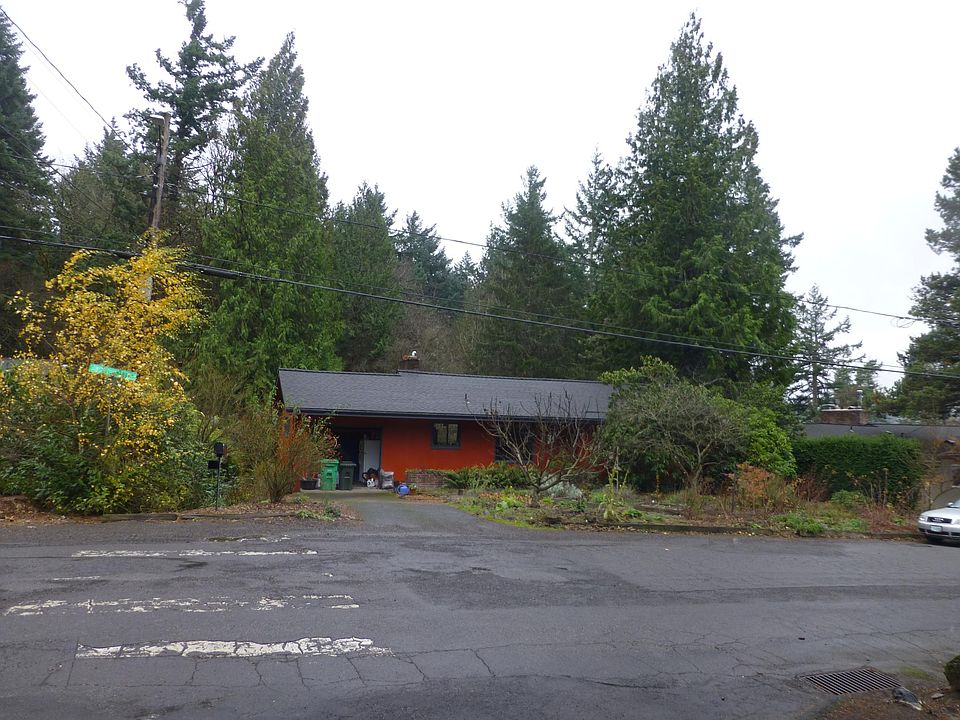 Street view of the home with forest in back