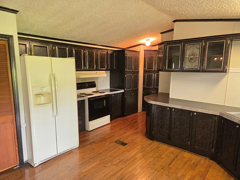 Kitchen including range/oven and refrigerator