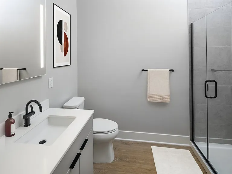 Signature Collection bath with LED vanity mirror, white quartz countertop, light grey cabinetry, walk-in shower, and hard surface flooring