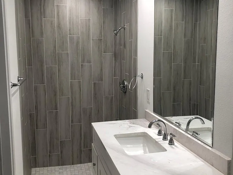 Master bath with walk in shower and exit to garage.