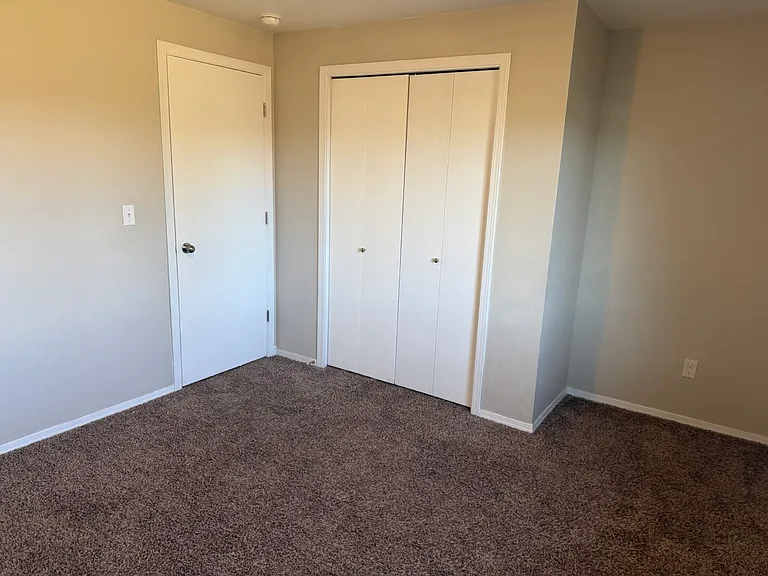 Third bedroom, featuring blinds and a closet as well. Both non-primary bedrooms feature closets of this size.
