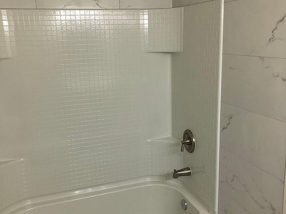 Remodeled Bathroom with Brand New Tile Walls, Floors, and Bathtub (July 2022)